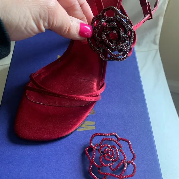Stuart Weitzman “Ramblin Rose” heels in ruby red satin with matching brooch.