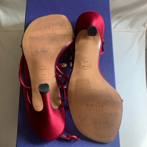 Stuart Weitzman “Ramblin Rose” heels in ruby red satin with matching brooch.